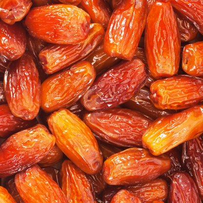 Close-up of Aurum Tunisian Deglet Noor pitted dates showing glossy texture and rich amber color